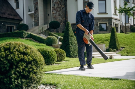 Lawn maintenance crew mowing bermuda lawn columbia sc neighborhood